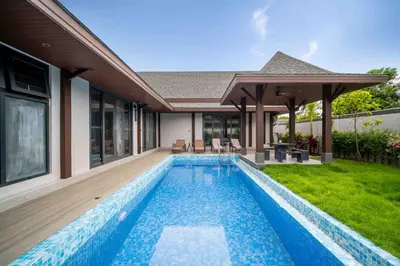 a swimming pool in the backyard of a house at summer stay pool villa in Ban Na Bon