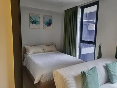 a bedroom with two beds and a window at Sky Park Laguna F4 in Laguna Phuket