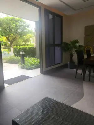 a room with a glass door with a table and chairs at Sky Park Laguna F4 in Laguna Phuket
