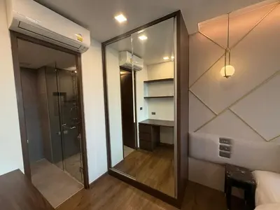 a bathroom with a walk in shower and a glass door at New 1BR Apartment in The Proud Karon Phuket in Karon Beach