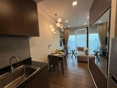 a kitchen and living room with a dining room at New 1BR Apartment in The Proud Karon Phuket in Karon Beach