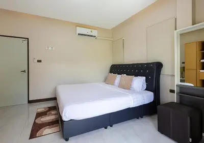 a bedroom with a bed with white sheets and pillows at Haleema Signature Villa - Bangtao Beach in Ban Thalat Choeng Thale