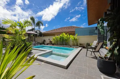a swimming pool in the middle of a patio with plants at Haleema Signature Villa - Bangtao Beach in Ban Thalat Choeng Thale