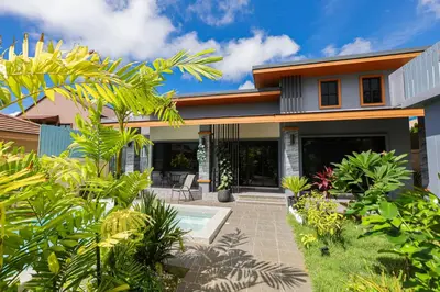 a house with a courtyard with plants at Haleema Signature Villa - Bangtao Beach in Ban Thalat Choeng Thale