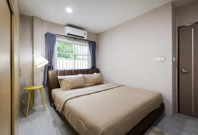 a bed in a small room with a window at Leema Beach Villa - Bangtao in Ban Thalat Choeng Thale