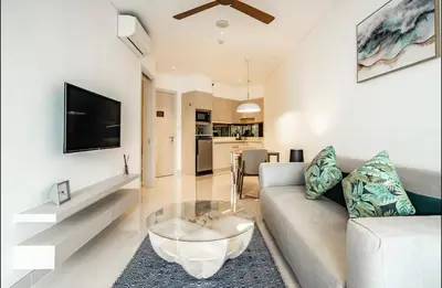 a living room with a couch and a coffee table at Cassia 1 bedroom in Bang Tao Beach