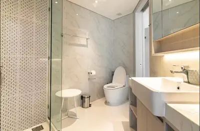 a bathroom with a toilet and a sink and a shower at Cassia 1 bedroom in Bang Tao Beach