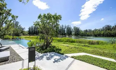 a view of a river with a sign in the foreground at Cassia 1 bedroom in Bang Tao Beach