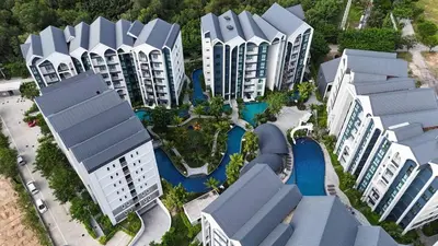 an aerial view of a resort with a pool at Modern 1 & 2 Bedroom Apartments Naiyang Phuket by Mango Family in Nai Yang Beach
