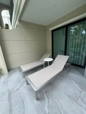 a white bench in a room with a window at Legendary Bang Tao in Phuket
