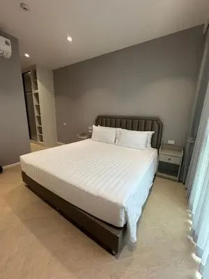 a bedroom with a large bed with white sheets and pillows at Legendary Bang Tao in Phuket
