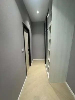 a hallway with a door and shelves in a room at Legendary Bang Tao in Phuket