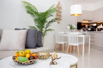 a living room with a bowl of fruit on a table at Cassia Residences - 1BDR - Sea view in Laguna Phuket