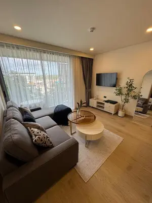 a living room with a couch and a table at New luxury condo Ozone next to Laguna in Phuket