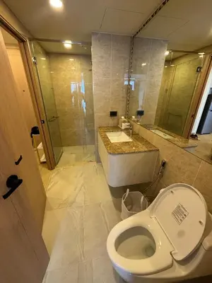 a bathroom with a toilet and a sink and a shower at New luxury condo Ozone next to Laguna in Phuket