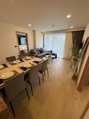a living room with a long table and chairs at New luxury condo Ozone next to Laguna in Phuket