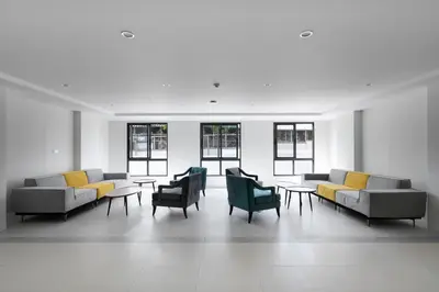 a room with couches and chairs and tables and windows at Fantasea Condo Kamala B502 1BDRM by Phuket Sabay Rent in Kamala Beach