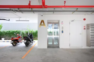 a motorcycle parked in a parking lot next to a door at Fantasea Condo Kamala B502 1BDRM by Phuket Sabay Rent in Kamala Beach
