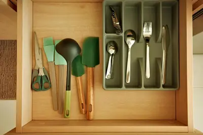 a wooden cabinet with utensils in it at Fantasea Condo Kamala B502 1BDRM by Phuket Sabay Rent in Kamala Beach