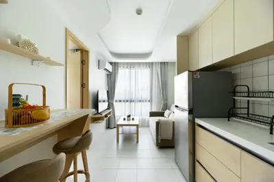 a kitchen with a refrigerator and a table in a room at Fantasea Condo Kamala B708 1BDRM by Phuket Sabay Rent in Kamala Beach