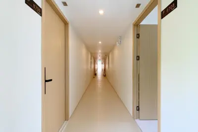 a corridor in a hospital hallway with a long aisle at Fantasea Condo Kamala B708 1BDRM by Phuket Sabay Rent in Kamala Beach
