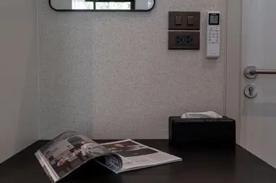 a newspaper sitting on a table next to a door at Title Halo Time For Family Pool Gym Hammam in Nai Yang Beach
