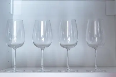 four empty wine glasses sitting on a shelf at Title Halo Time For Family Pool Gym Hammam in Nai Yang Beach