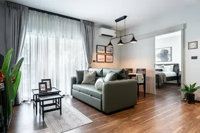 a living room with a couch and a bedroom at Title Halo Time For Family Pool Gym Hammam in Nai Yang Beach
