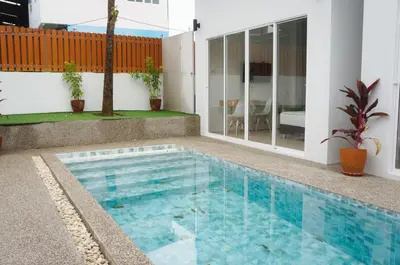 a swimming pool in front of a house at A&J Holiday Villa in Ban Na Bon