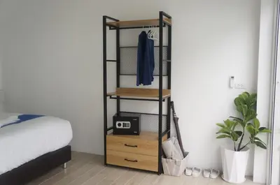 a bedroom with a black shelf with a toaster on it at A&J Holiday Villa in Ban Na Bon