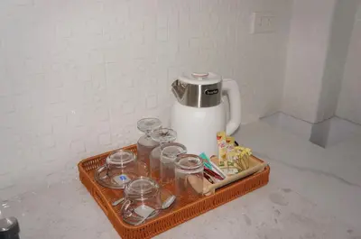a tray with glasses and a tea kettle on a counter at A&J Holiday Villa in Ban Na Bon