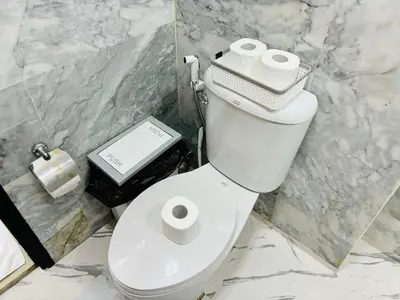 a bathroom with a toilet with two rolls of toilet paper at MBC Condotel Maikhao beach in Mai Khao Beach