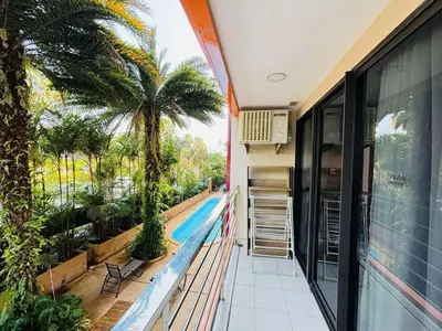 a balcony of a house with a swimming pool at MBC Condotel Maikhao beach in Mai Khao Beach