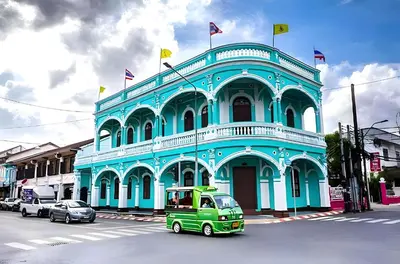 a green truck parked in front of a blue building at xx Mitr Inn - Phuket Old Town มิตรอินน์ ภูเก็ต เมืองเก่า 3 in Phuket Town