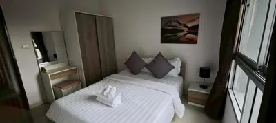 a bedroom with two beds with towels on them at Chic B309 in Karon Beach