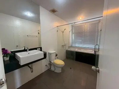 a white bathroom with a sink and a toilet at Chic B309 in Karon Beach