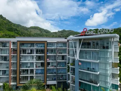 a view of a hotel with mountains in the background at Chic B309 in Karon Beach
