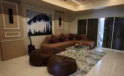 a living room with a brown couch and a table at Palm Spring 301 in Patong Beach