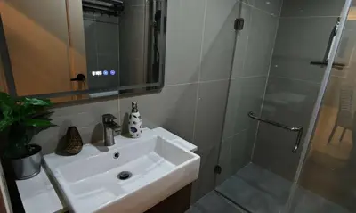 a bathroom with a sink and a shower at Palm Spring 301 in Patong Beach