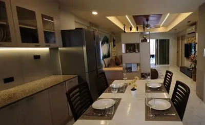 a dining room with a table and chairs in a kitchen at Palm Spring 301 in Patong Beach