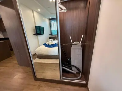 a mirror in a room with a room with a bed at Cozy 2BR Apartment in The Proud Karon Beach in Karon Beach