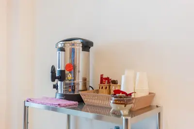 a blender sitting on top of a metal shelf at Thawalai Inn Kata in Kata Beach