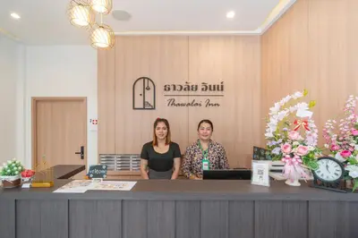 two women standing at a counter in a salon at Thawalai Inn Kata in Kata Beach