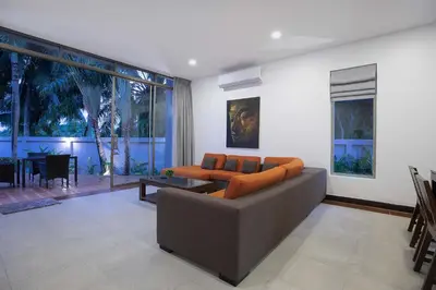 a living room with a couch and a table at 3 BR Villa with swimming pool near golf and airport - Argent 10 in Thalang