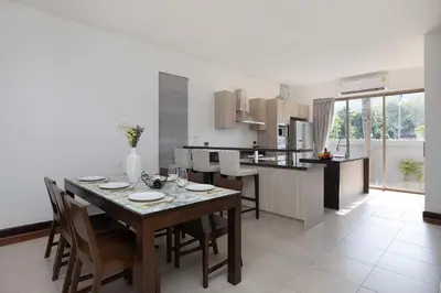 a kitchen and dining room with a table and chairs at 3 BR Villa with swimming pool near golf and airport - Argent 10 in Thalang