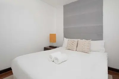 a bedroom with a white bed with a towel on it at 3 BR Villa with swimming pool near golf and airport - Argent 10 in Thalang