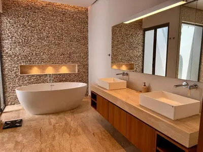 a bathroom with a large tub and a large mirror at Peaceful villa in the heart of the Anchan Tropicana project in Ban Phru Champa