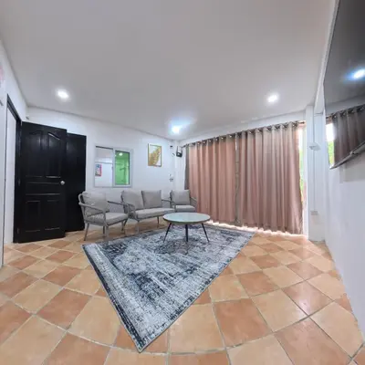 a living room with a couch and a table at Stay 94 Patong in Patong Beach