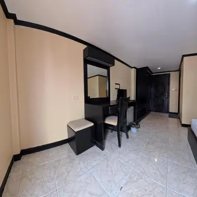 a living room with a desk and a mirror at Stay 94 Patong in Patong Beach