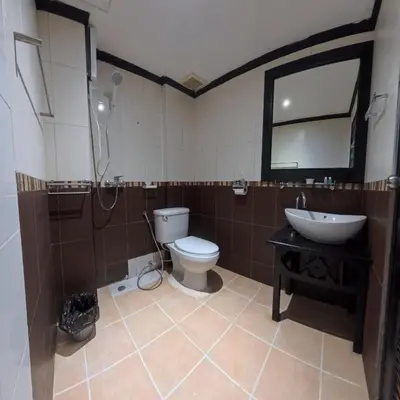 a bathroom with a toilet and a sink and a mirror at Stay 94 Patong in Patong Beach